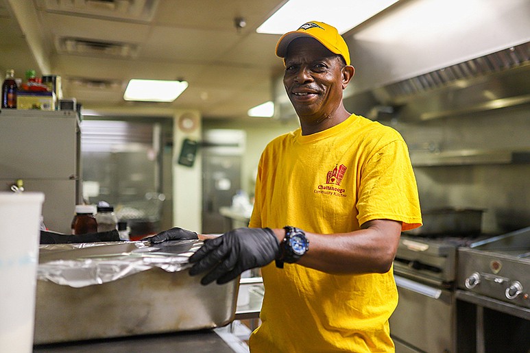 Staff photo by Olivia Ross / Prince Appleberry covers a pan of food at Chattanooga Community Kitchen.