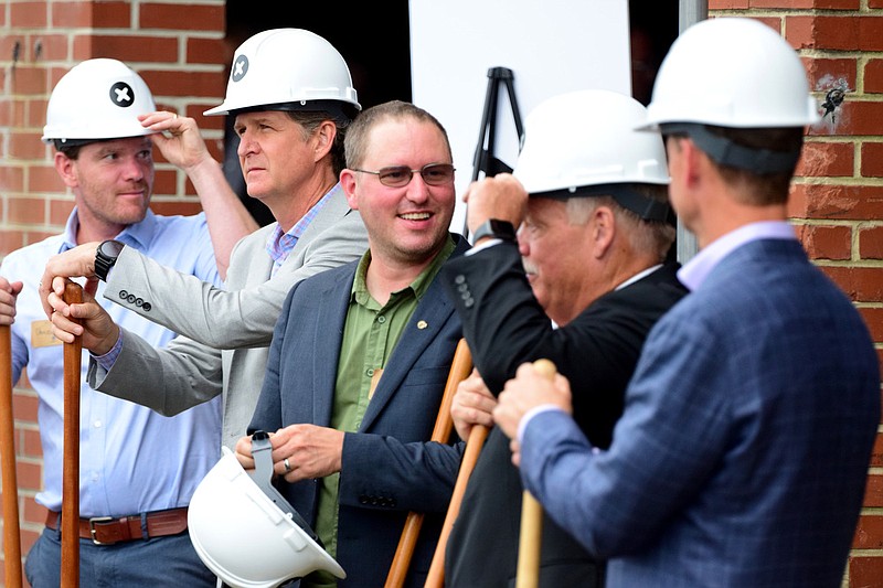 Staff Photo by Robin Rudd / Kyle Wiens, CEO of iFixit, center, adjusts his hard hat before the groundbreaking.  Joining Mr. Wiens, from left are Daniel Wiens Construction Manager for iFixit, Chattanooga Mayor Tim Kelly, Hamilton County Mayor Jim Coppinger and Tennessee Depart of Economic and Community Development, Stuart McWhorter.  iFixit, a California based company, announced plans to expand into Chattanooga, with 70,000 square foot facility on East 12th Street, on June 19, 2022.