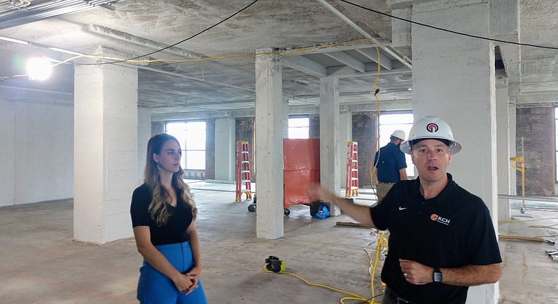 Staff photo by Mike Pare / KCH Transportation Chief Executive Jason Whitten, right, on Tuesday talks about the space his company is leasing at King Street Station. At left is Megan Freeman, senior leasing agent for building owner Urban Story Ventures.