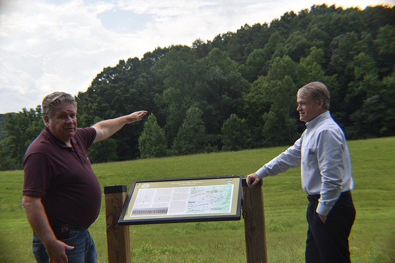 Staff Photo by Andrew Wilkins / On Tuesday, Bob Sivick, Whitfield County's administrator (left), describes a Civil War-era skirmish that took place in a natural bowl near Rocky Face Ridge while Jevin Jensen, chairman of the Whitfield County Board of Commissioners (right), looks on.
