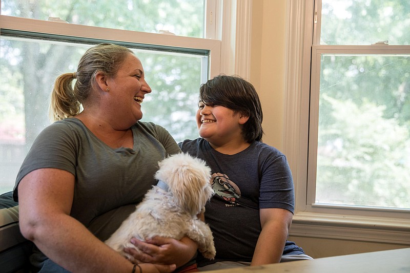 Teresa Acosta and her son Bauer, 13, sit in their home in Dunwoody, Ga. Bauer lives with Type 1 diabetes, which forces him to rely on a strict regimen of prescribed insulin to survive. / Georgia Public Broadcasting