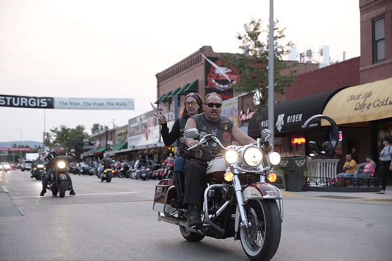 AP Photo/Stephen Groves / Motorcycles cruise through downtown Sturgis, S.D., in August 2021.