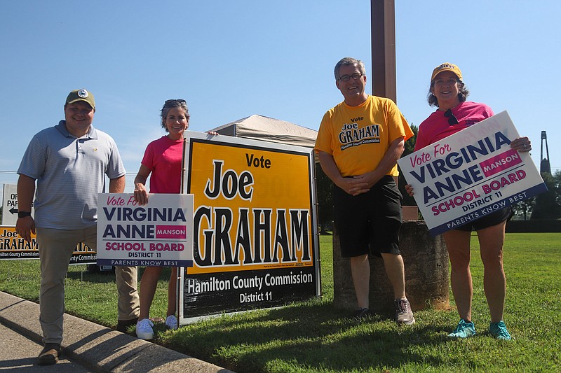 Staff Photo By Olivia Ross / From left, Dalton Temple, Virginia Anne Manson, Joe Graham and Maddin Corey greet voters outside the Hamilton County Election Commission on the first day of early voting earlier this month.