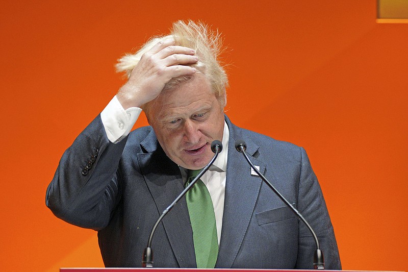 Photo by Peter Byrne/Pool Photo via The AP / British Prime Minister Boris Johnson adjusts his hair as he speaks at the the Commonwealth Business Forum at the ICC in Birmingham, England, on Thursday, July 28, 2022.