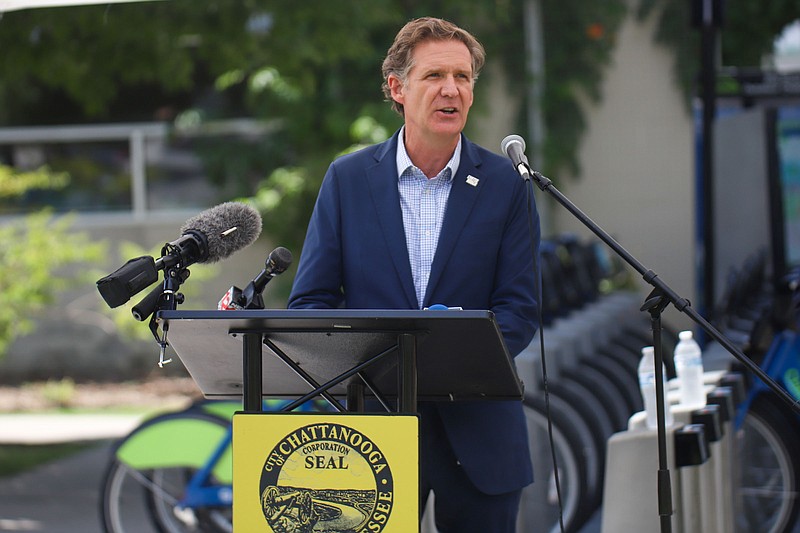 Staff Photo by Olivia Ross / Mayor Tim Kelly speaks outside of Outdoor Chattanooga on Thursday. Many gathered to celebrate the 10th anniversary of Chattanooga's bicycle and bike rent program.