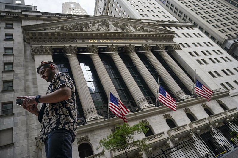 FILE - Pedestrians walk past the New York Stock Exchange, July 8, 2022, in New York. Stocks are opening slightly higher on Wall Street Thursday, July 28, 2022 following news the U.S. economy shrank for a second consecutive quarter. The S&P 500, Dow Jones Industrial Average and Nasdaq are each up a fraction of a percent. (AP Photo/John Minchillo, file)