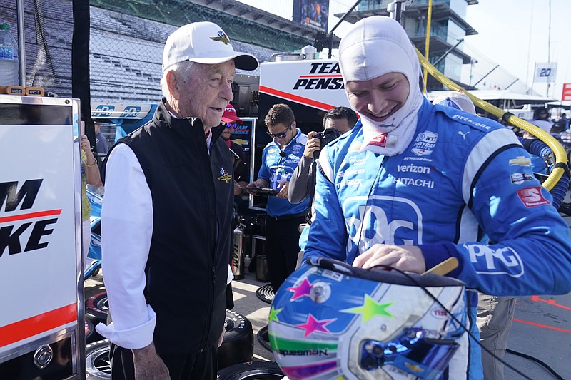 AP photo by Darron Cummings / Team owner Roger Penske, left, talks with driver Josef Newgarden before a practice session Friday for Saturday's IndyCar race on the road course at Indianapolis Motor Speedway.