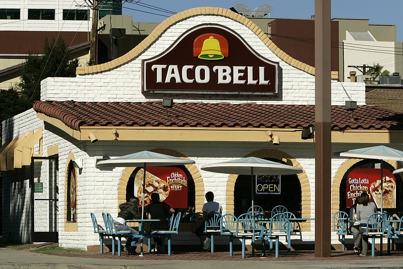 **FILE** Customers take advantage of sunny skies and eat outside a Taco Bell restaurant in this Dec. 5, 2006, file photo in Burbank, Calif. Fast-food chain operator Yum Brands Inc. is expected to release earnings on Monday, Oct. 8, 2007. (AP Photo/Ric Francis, file)