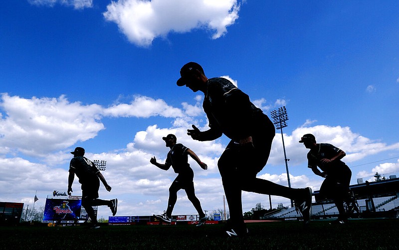 AP photo by Charlie Neibergall / Quad Cities River Bandits players warm up before a Class-A Midwest League game against the host Cedar Rapids Kernels on May 13, 2019, in Iowa. Leaders of the Senate Judiciary Committee have asked baseball commissioner Rob Manfred to explain the impact of potential legislation stripping MLB's antitrust exemption from covering the sport's relationship with minor league players.