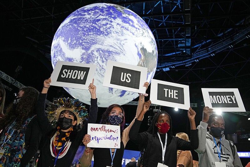 Climate activist Vanessa Nakate, second right, and other activists engage in a 'Show US The Money' protest at the COP26 U.N. Climate Summit in Glasgow, Scotland, Nov. 8, 2021. Richer countries failed to keep a $100 billion-a-year pledge to developing nations to help them achieve their climate goals, according to an analysis by the Organization for Economic Cooperation and Development, or OECD, released Friday, July 29, 2022. (AP Photo/Alastair Grant, File)