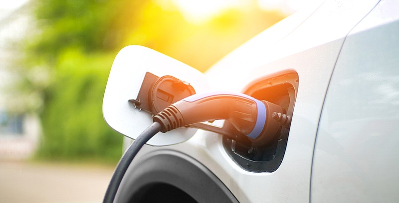 Electric vehicle charging at power station, EV charger. / Getty Images/iStock/deepblue4you