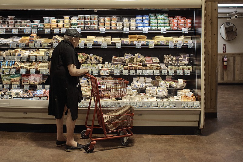 A man shops at a supermarket on Wednesday in New York. An inflation gauge that is closely tracked by the Federal Reserve jumped 6.8% in June from a year ago, the biggest increase in four decades, and leaving Americans with no relief from surging costs.