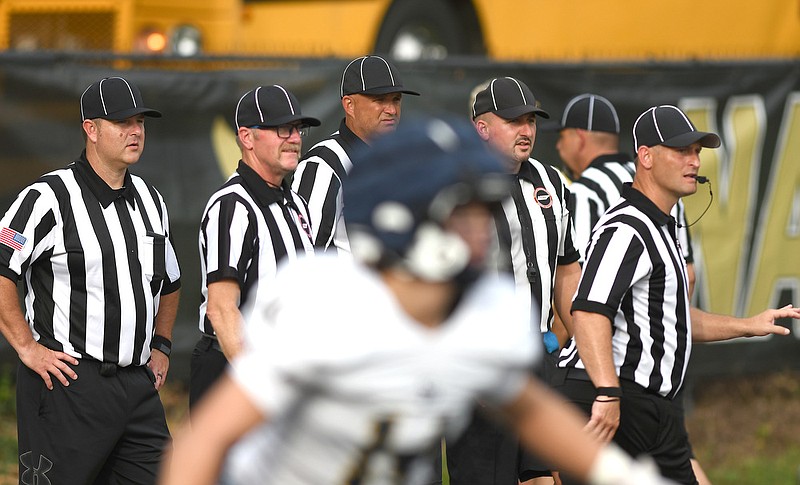 Staff photo by Robin Rudd / High school football officials concentrate on the action during a scrimmage Friday at Bradley Central that also included Baylor, Chattanooga Christian, Notre Dame and Soddy-Daisy. A shortage of officials in Tennessee led the TSSAA to first require and then recommend that each member school schedule at least one game for a Thursday night this season.