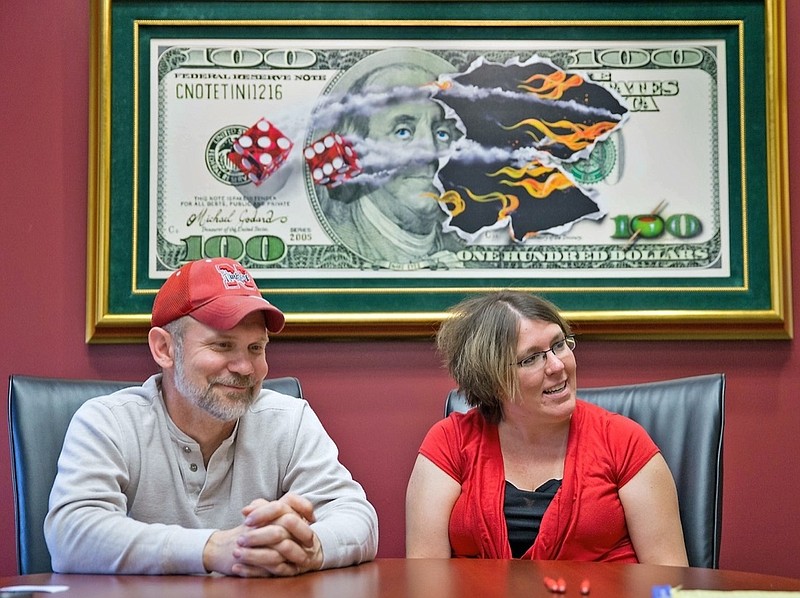 FILE - Powerball lottery winners David, left, and Erica Harrig, of Gretna, Neb., speak during an interview at the law office of their attorney Darren Carlson in Omaha, Neb., on Dec. 13, 2013. (Kent Sievers /Omaha World-Herald via AP, File)