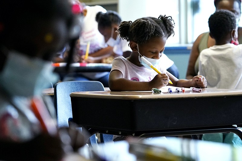 Laiah Collins, 4, center, works on artworks during a class at Chalmers Elementary school in Chicago, Wednesday, July 13, 2022. America's big cities are seeing their schools shrink, with more and more of their schools serving small numbers of students. Those small schools are expensive to run and often still can't offer everything students need (now more than ever), like nurses and music programs. Chicago and New York City are among the places that have spent COVID relief money to keep schools open, prioritizing stability for students and families. But that has come with tradeoffs. And as federal funds dry up and enrollment falls, it may not be enough to prevent districts from closing schools. (AP Photo/Nam Y. Huh)