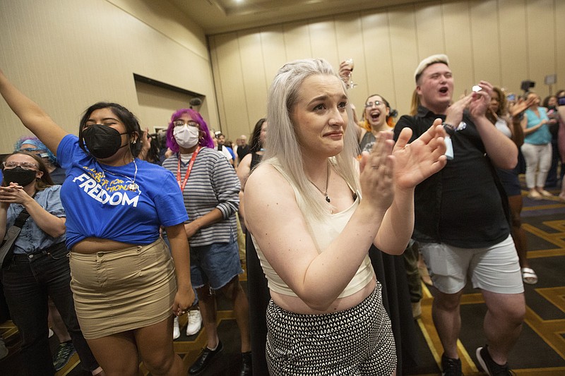 Photo by Evert Nelson/The Topeka Capital-Journal via The AP / Allie Ugley, middle, an Allen County resident, holds back tears after hearing the news that the "No" votes won on a proposed amendment to the Kansas Constitution from the Kansans for Constitutional Freedom election watch party at the Overland Park Convention Center in Overland Park, Kan., on Tuesday, Aug. 2, 2022.