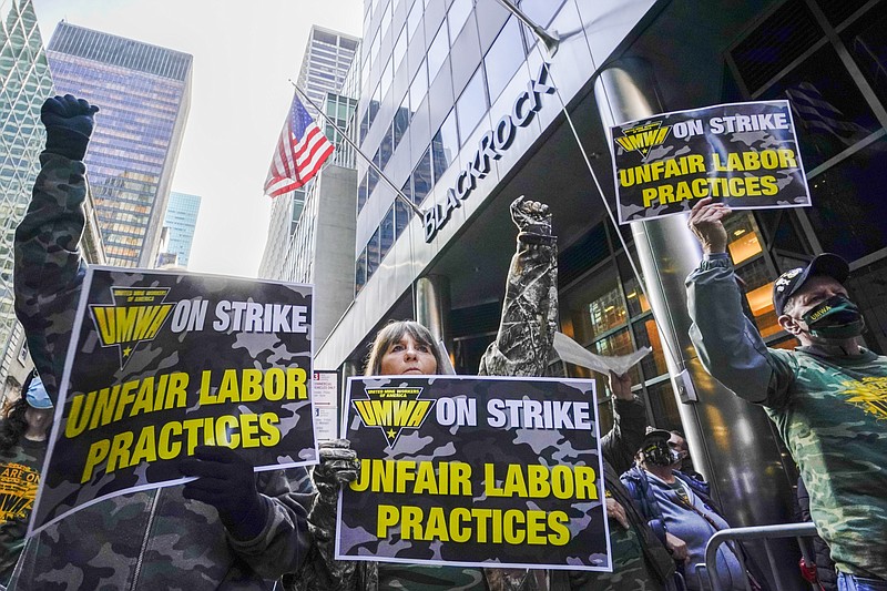 FILE - Members and supporters of the of the United Mine Workers of America demonstrate outside BlackRock headquarters on Nov. 4, 2021, in New York. A federal oversight board ordered the United Mine Workers of America on July 22, 2022, to pay more than $13 million in compensation to an Alabama coal company where members have been on strike for more than a year, a ruling the union said Wednesday, Aug. 3, it would challenge. (AP Photo/Mary Altaffer, File)