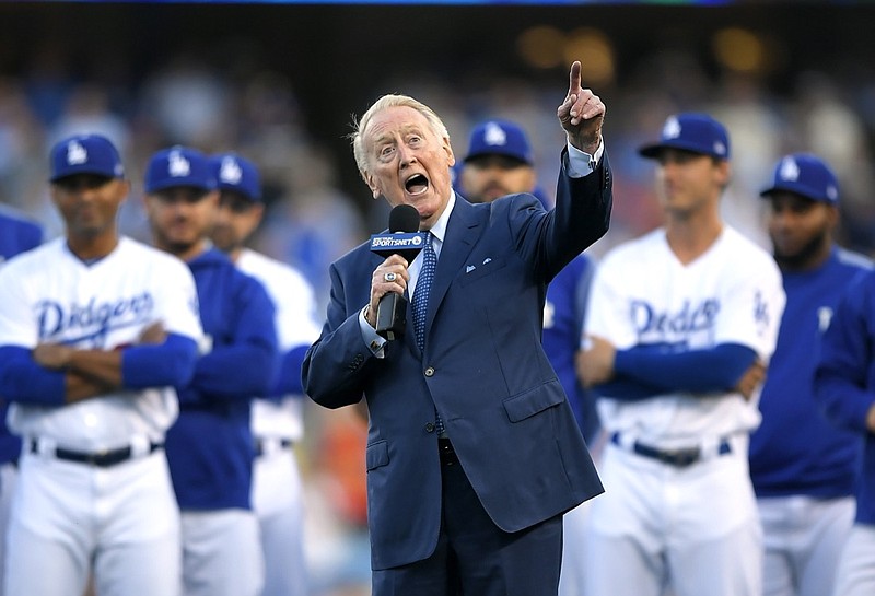 FILE - Los Angeles Dodgers broadcaster Vin Scully speaks during his induction into the team's Ring of Honor prior to a baseball game between the Dodgers and the San Francisco Giants in Los Angeles on May 3, 2017, in Los Angeles. Scully, whose dulcet tones provided the soundtrack of summer while entertaining and informing Dodgers fans in Brooklyn and Los Angeles for 67 years, died Tuesday night, Aug. 2, 2022, the team said. He was 94. (AP Photo/Mark J. Terrill, File)