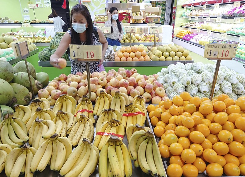 FILE - Customers buy fruit at a stall in Taipei, Taiwan, Sept. 20, 2021. China has blocked imports of citrus and fish from Taiwan in retaliation for a visit to the self-ruled island by a top American lawmaker but avoided sanctions on Taiwanese processor chips for Chinese assemblers of smartphones and other electronics, a step that would send shockwaves through the global economy. (AP Photo/Chiang Ying-ying, File)