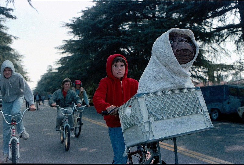 Universal Pictures / With help from his neighborhood friends, Elliott (Henry Thomas) escapes from U.S. government officials with E.T. in his bicycle basket in "E.T. the Extra-Terrestrial." A weeklong 40th anniversary run of the Steven Spielberg film starts Aug. 11 at the Tennessee Aquarium's Imax Theater.
