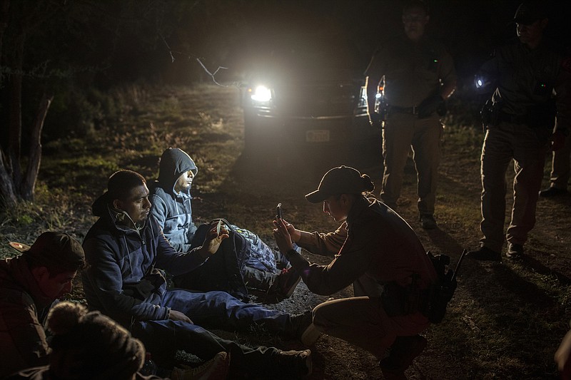 File photo by Kirsten Luce of The New York Times / A group of migrants who said they were from Mexico are photographed after they were apprehended in Kinney County, Texas, on Nov. 17, 2021.