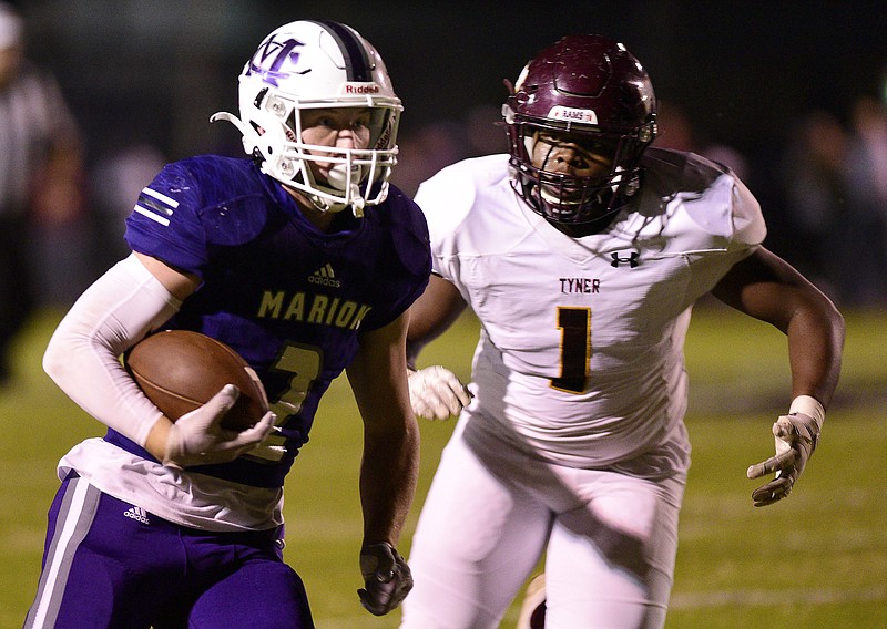 Staff photo by Robin Rudd / Marion County's Alex Condra picks up yardage after making a catch as Tyner's Jersey Chubb chases during a Region 3-2A matchup in October 2021 in Jasper, Tenn. Condra and Chubb both return as key players for their teams this fall.