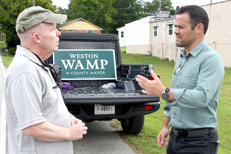 Staff file photo by Robin Rudd / Weston Wamp, right, talks with Stan Burton outside the Harrison polling place. Wamp was elected Hamilton County mayor on Thursday — primarily on his position that Hamilton County has better things to spend tax money on than a new Lookouts stadium. But has that train left the station?