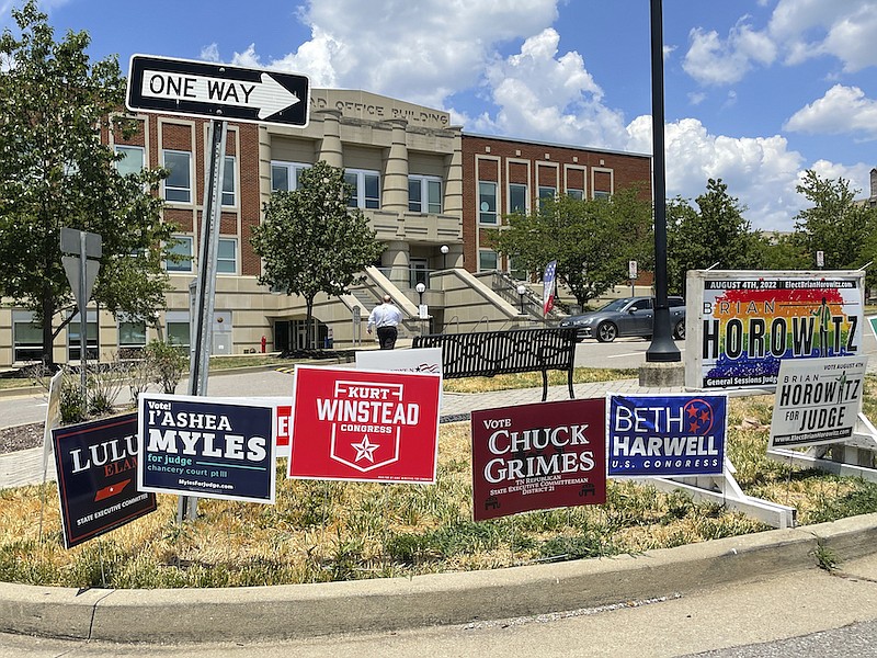 Campaign signs are posted outside a polling location on the first day of early voting July 15, 2022, in Nashville, Tenn. GOP lawmakers redistricted the left-leaning city early this year, splitting its one seat into three to help Republicans gain a seat. (AP Photo/Jonathan Mattise)