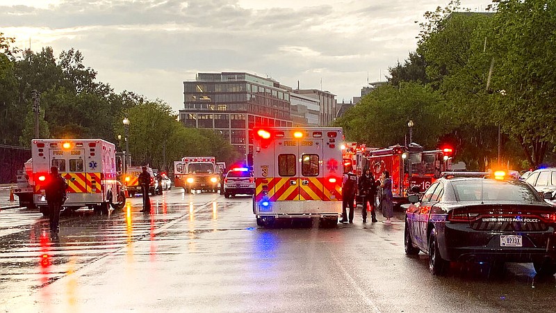 In this photo provided by @dcfireems, emergency medical crews are staged on Pennsylvania Avenue between the White House and Lafayette Park, Thursday evening, Aug. 4, 2022 in Washington. Two people who were critically injured in a lightning strike in Lafayette Park outside the White House have died, police said Friday. Two others remained hospitalized with life-threatening injuries. Authorities haven't revealed how the people were injured, other than to say they were critically hurt in the lightning strike. (@dcfireems via AP)