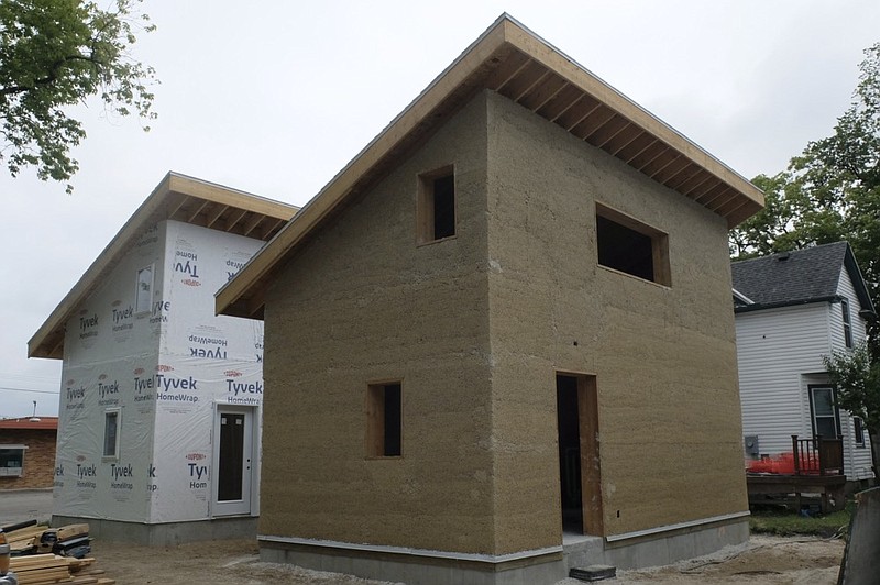 A hempcrete home under construction in in Fargo, N.D., in July 2022, is the focus of research comparing the hemp building material with a traditional wood frame house. The two small houses are on the back half of a lot just off a busy street, not far from downtown Fargo. (Dan Gunderson/Minnesota Public Radio via AP)