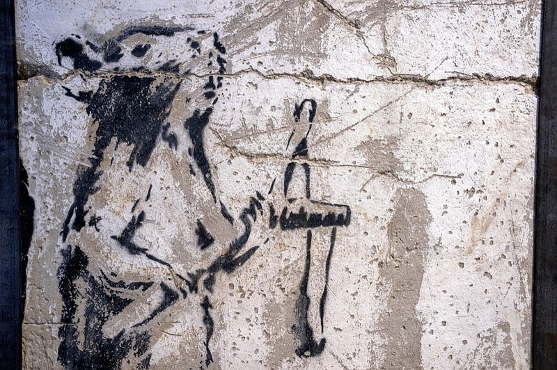 A painting by the secretive British graffiti artist Banksy that was mysteriously transferred from the occupied West Bank is revealed in Urban Gallery in Tel Aviv, Israel, Thursday, Aug. 4, 2022. The painting of a slingshot-toting rat once stood near Israel's separation barrier and was one of several works created in 2007 that protest Israel's decades-long occupation of territories the Palestinians want for a future state. (AP Photo/Oded Balilty)