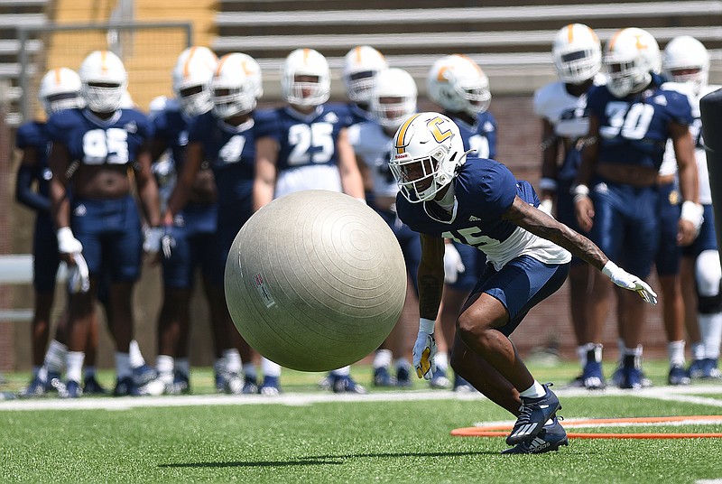 Staff photo by Matt Hamilton / UTC defensive back Kam Brown practices his tackling on a large ball during the Mocs' spring football showcase in April at Finley Stadium. Brown and Reuben Lowery are good candidates for bigger roles this season for a defense that was No. 1 in the SoCon last year.