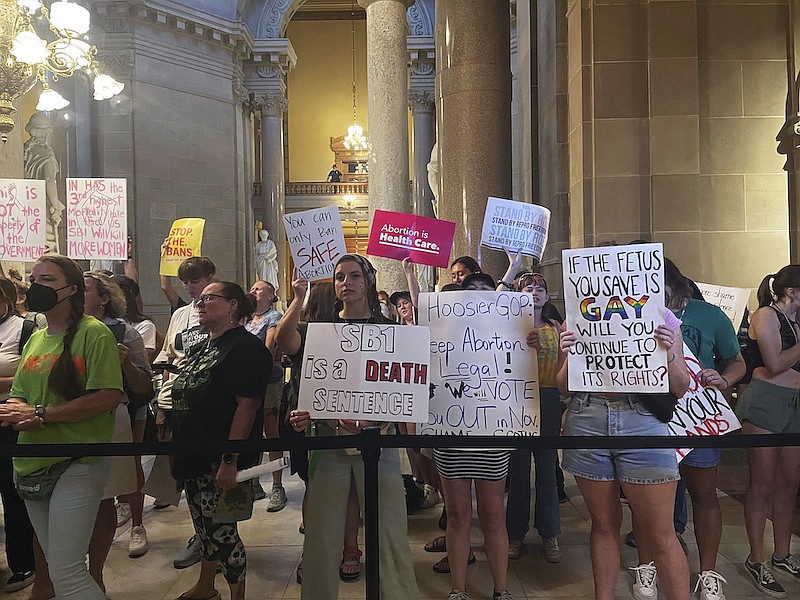 Abortion-rights protesters fill Indiana Statehouse corridors and cheer outside legislative chambers, Friday, Aug. 5, 2022, as lawmakers vote to concur on a near-total abortion ban, in Indianapolis. (AP Photo/Arleigh Rodgers)