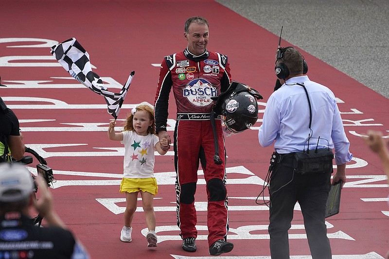 AP photo by Paul Sancya / Stewart-Haas Racing driver Kevin Harvick celebrates with his daughter Piper after winning Sunday's NASCAR Cup Series race at Michigan International Speedway. It was the 59th win of his Cup Series career but his first in 65 races.