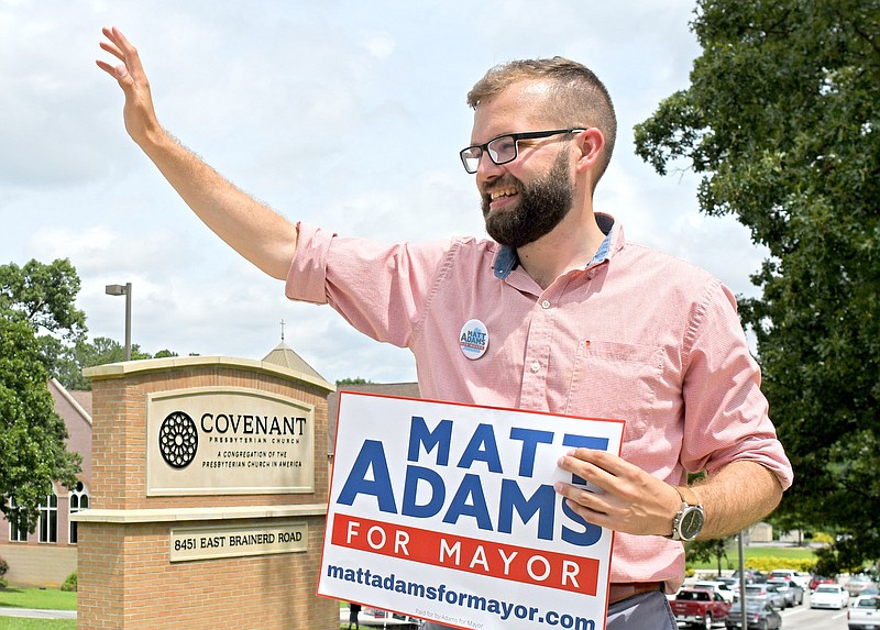 Staff Photo By Robin Rudd / Democratic mayoral candidate Matt Adams stumps for votes as he campaigns outside the polling place at Covenant Presbyterian Church last week.