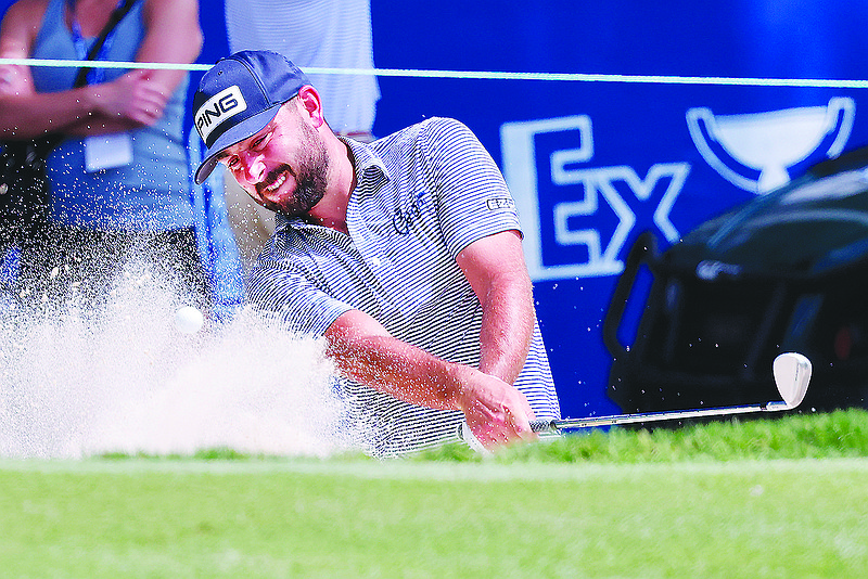 Stephan Jaeger hits from the bunker on the 18th hole during the first round of the Wyndham Championship golf tournament, Thursday, Aug. 4, 2022, in Greensboro, NC. (AP Photo/Reinhold Matay)