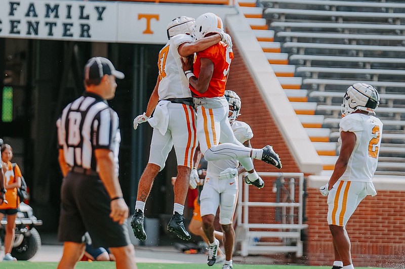 Tennessee Athletics photo / Tennessee tight end Jacob Warren, left, and quarterback Hendon Hooker celebrate during Tuesday's first preseason scrimmage inside Neyland Stadium.