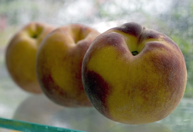 Peaches are shown in this 2007 photo. While peaches are available nearly year round, July and August is when the seasons heat and sunshine has really filled the fruit with sugar. (AP Photo/Larry Crowe)