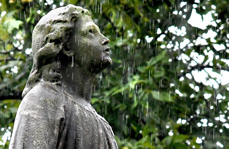 An angel, atop a monument in St. Elmo's Forest Hills Cemetery, appears to look skyward into the steady rain. Heavy rains caused flash flooding, and other disruptions in the Chattanooga area on August 10, 2022. /  Staff Photo by Robin Rudd
