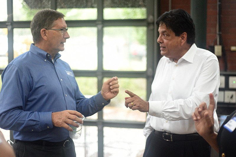 Staff Photo by Matt Hamilton / Tommy Nix, left, vice president of Tennessee Valley Federal Credit Union, talks to Double Cola CEO Alnoor Dhanani at the Miller Plaza Waterhouse Pavilion on Wednesday. The Chattanooga companies are sponsoring "Idea Leap" and "Will It Float?" competitions this fall to aid startup businesses.