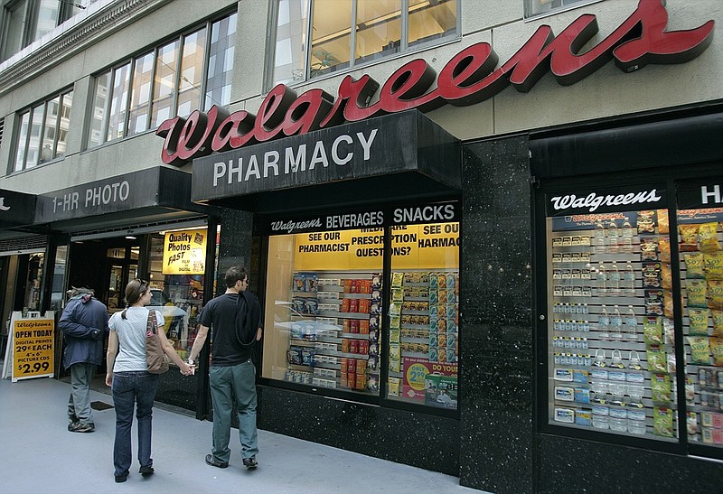 Window shoppers look at a Walgreens storefront in San Francisco on June 26, 2006. (AP Photo/Ben Margot, File)