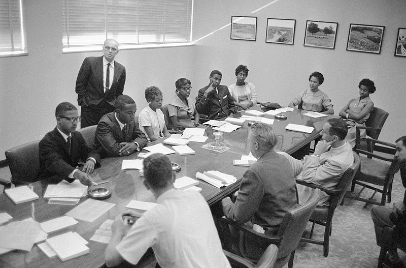 These eight African-Americans were the first in the history of Memphis State University to register for classes at the formally all white school in Memphis, Tenn., Sept. 10, 1959. At a press conference during registration are from left, Ralph Prater, Luther McClellan, Joyce Gandy, Bertha Rogers, John Simpson, Rosie Blakney, Sammie Burnett and Marvis Kneeland. Dean R.M. Robison is in background. Prater, one of the first Black students to enroll at then-Memphis State University in 1959, died on Sunday, Aug. 7, 2022. He was 81. (AP Photo/Perry Aycock, File)
