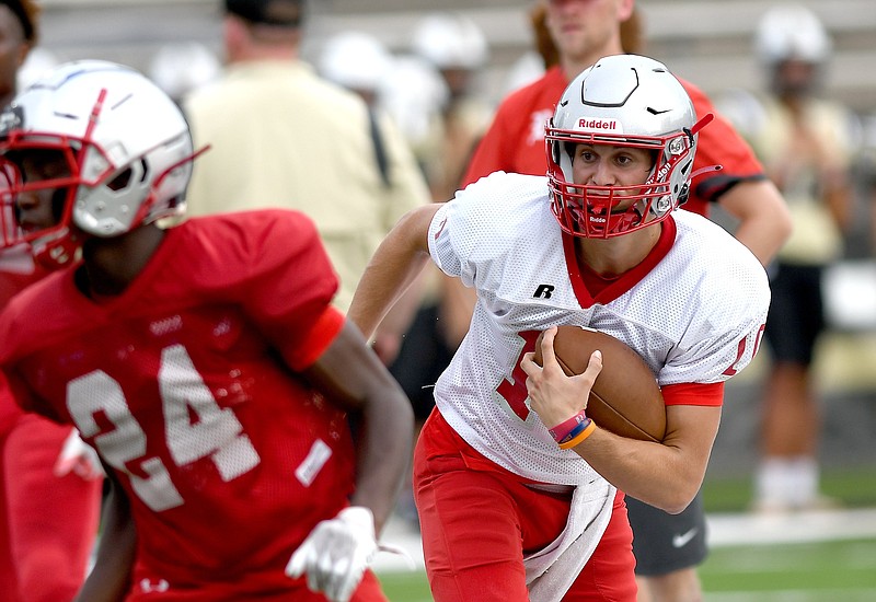 Staff photo by Robin Rudd / Baylor quarterback Whit Muschamp carries the ball during a scrimmage at Bradley Central High School.