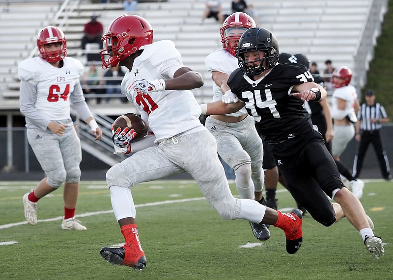 Staff file photo / Lakeview-Fort Oglethorpe senior wide receiver Trevon Gott, with ball, is part of a deep group of skill position talent on offense for the Warriors as they enter their first season under coach Mac Bryan.