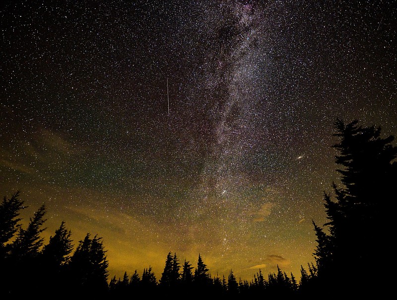 In this 30 second cameras exposure, a meteor streaks across the sky during the annual Perseid meteor shower, Wednesday, Aug. 11, 2021, in Spruce Knob, West Virginia. (Bill Ingalls/NASA via AP)


