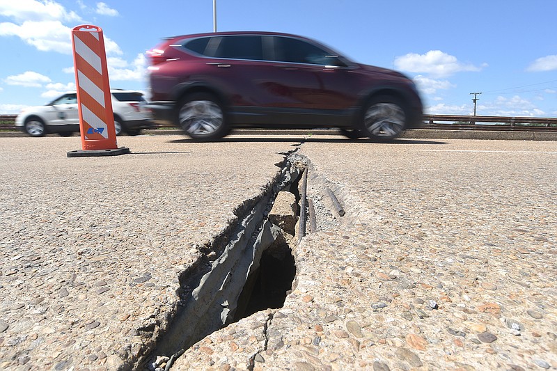 Staff photo by Matt Hamilton / Drivers pass over damaged areas on the Wilcox Boulevard Bridge on Friday. The bridge is due for $54.5 million of work.