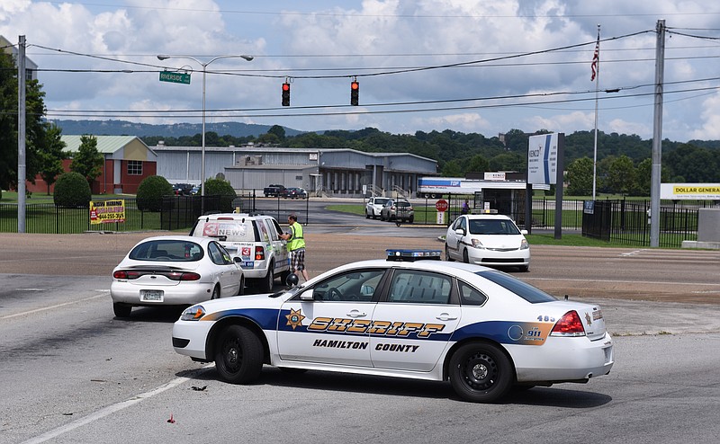 Staff File Photo / Police vehicles block the intersection of Amnicola Highway and Wilcox Boulevard, at the base of the bridge over Norfolk Southern railway yards, in response to a domestic terror incident at the Naval Reserve facility on Amnicola Highway in 2015.