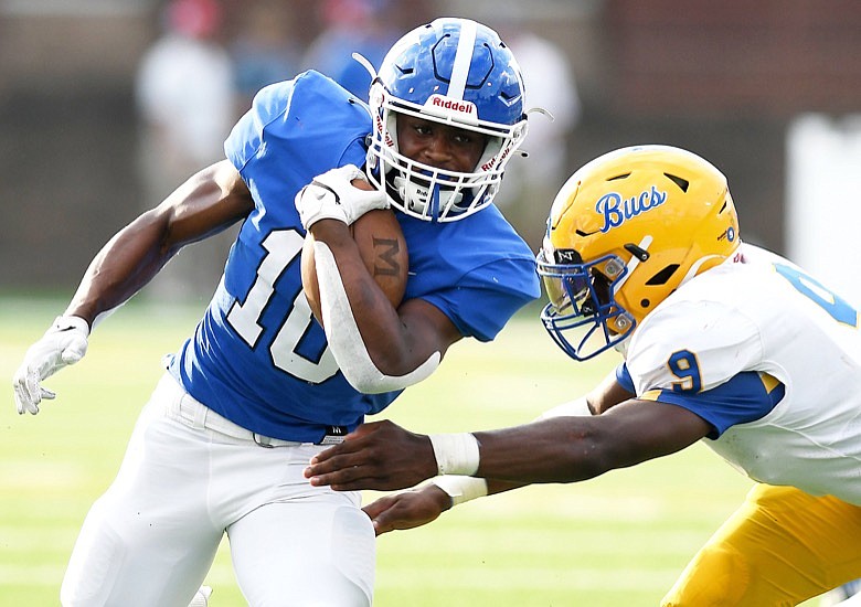 Staff Photo by Robin Rudd /  McCallie's Tario Price (10) avoids the tackle of Boyd Buchanan's Jaylon Standerfer (9).  The second night of the Best of Preps High School Football Jamboree was held August 12, 2022 at Finley Stadium.