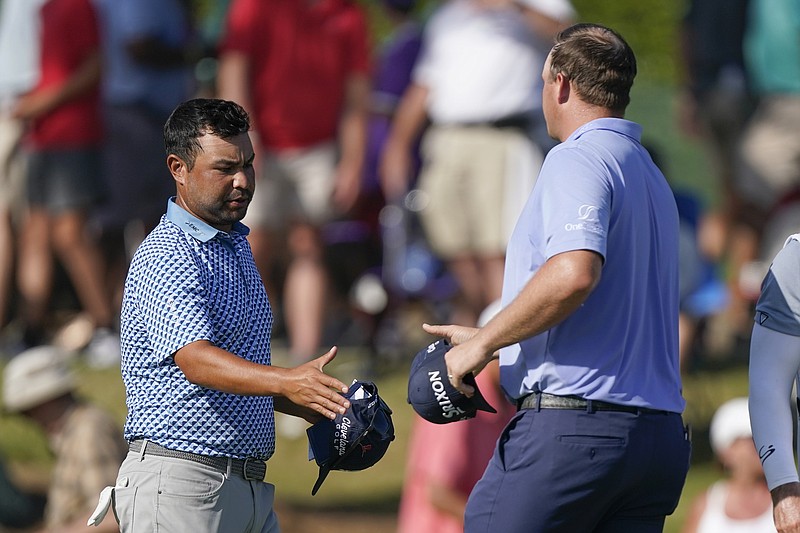 AP photo by Mark Humphrey / J.J. Spaun, left, greets Sepp Straka on the 18th green at TPC Southwind at the end of the third round of the FedEx St. Jude Championship on Saturday in Memphis. Spaun held a one-shot lead over Straka in the PGA Tour postseason opener.