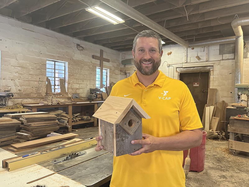 Staff File Photo by David Floyd / YMCA Community Action Program Executive Director Andy Smith stands in the organization's wood shop where students make birdhouses and cutting boards.